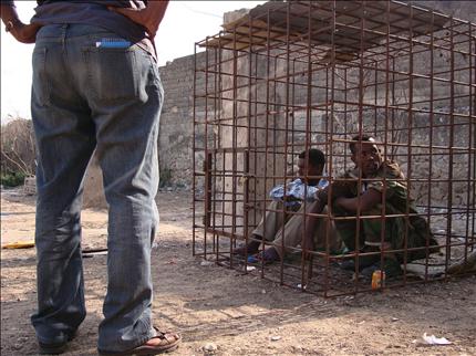 مقاتلان في جماعة صوفية موالية للحكومة الصومالية ينفذان عقوبة تأديبية بعد اتهامهما بعدم الانضباط، في المقر الرئيسي للمقاتلين الصوفيين في مقديشو أمس (أ ف ب) 