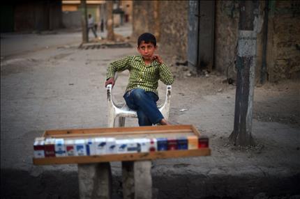 طفل سوري يبيع السجائر في شمالي مدينة حلب أمس الأول (أ ف ب) 