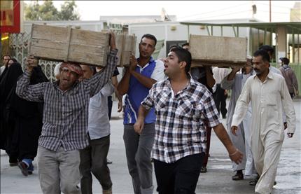 عراقيون يشيّعون ضحاياهم في مدينة النجف أمس (أ ب)
