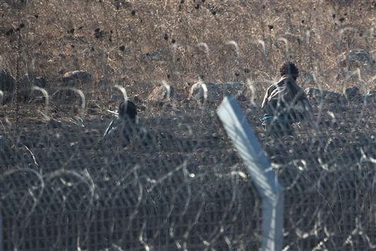مسلحان من "جبهة النصرة" قرب السياج الذي وضعته اسرائيل لفصل الجولان السوري المحتل عن القنيطرة (ا ف ب)
