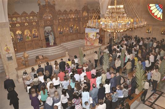 سوريون يشاركون في احتفال أحد السعف في كنيسة في حلب أمس (ا ف ب)
