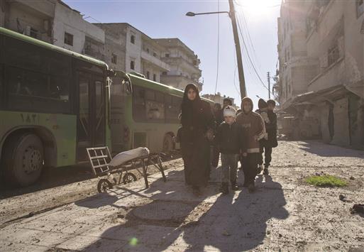سوريون خلال إجلائهم من المناطق التي يُسيطر عليها المُسلّحون في حلب أمس (ا ف ب)